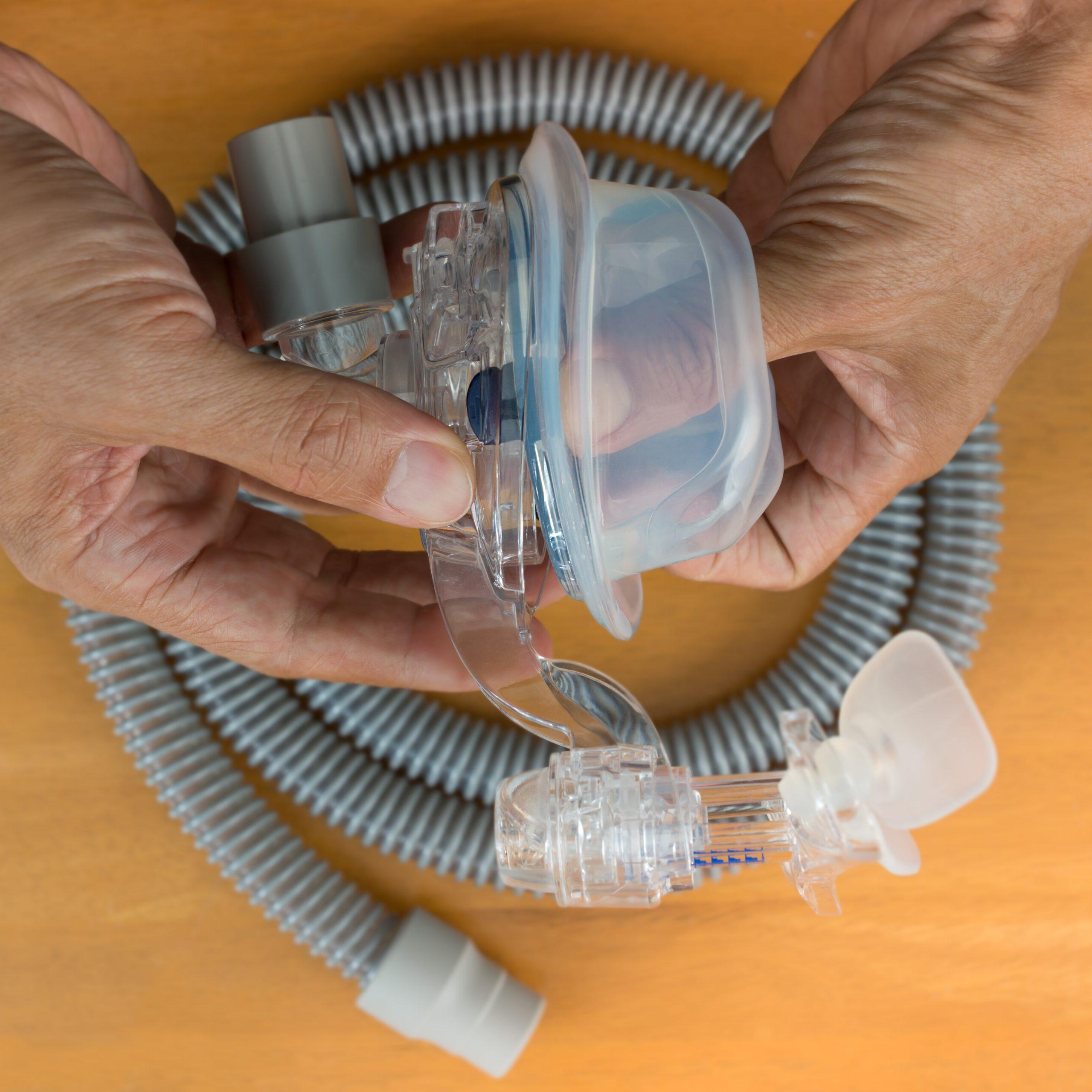 A person cleaning their CPAP mask.